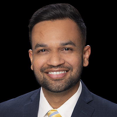 Orthodontist Dr. Darshit Shah smiling during a professional headshot at Crescent Dental & Orthodontics